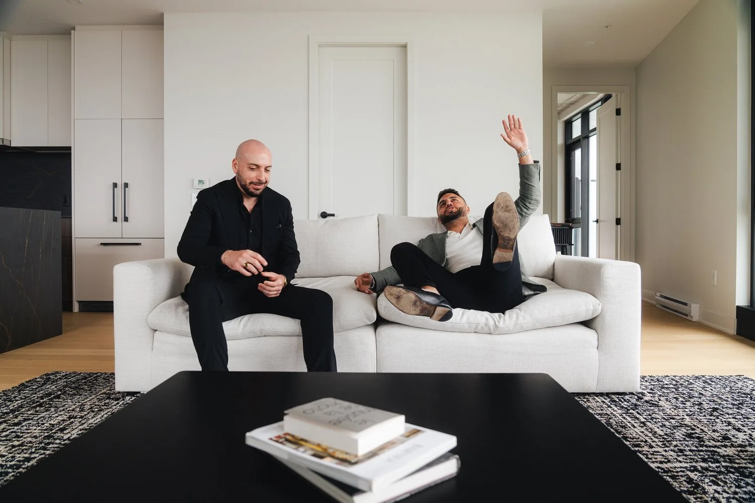 Eran Dahan and Jeremy Yassa in a bright lounge with white sofas