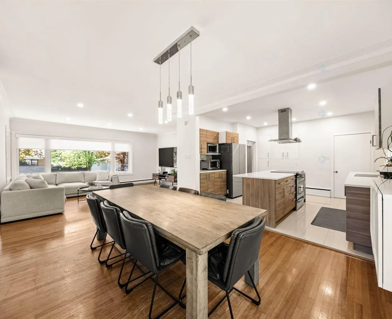 Dining room and kitchen at 5065 Rue Roméo in Pierrefonds-Roxboro, with a broad window