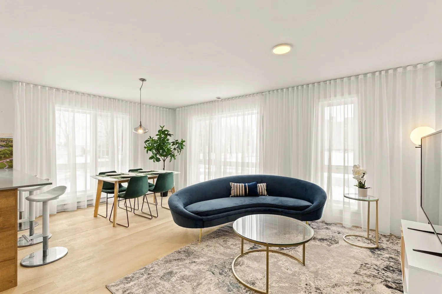 Vallea rental residence in Salaberry-de-Valleyfield, with a curved sofa and floor-to-ceiling curtains